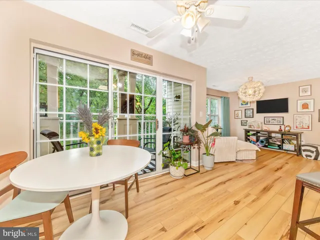 a kitchen with stainless steel appliances granite countertop wooden cabinets a stove top oven a sink and dishwasher with wooden floor