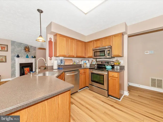 a kitchen with granite countertop a stove top oven and sink