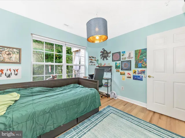 a bedroom with a bed table and window