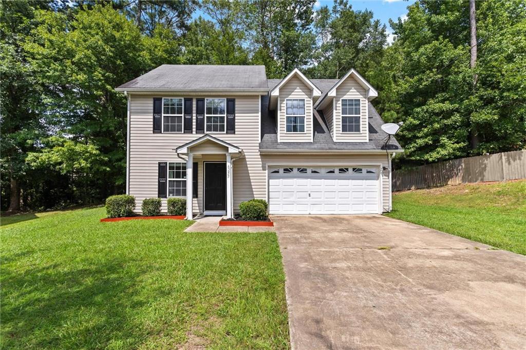 6255 Topaz Trail Atlanta, GA 30349 - Photo 1 of 1 a front view of a house with a yard and garage