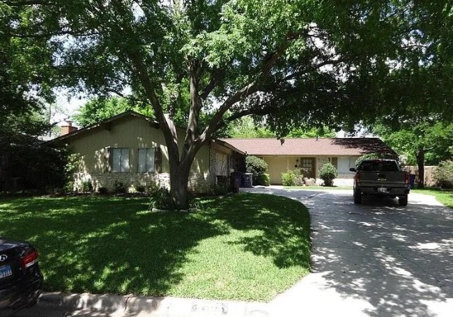 Ranch-style home featuring a front yard and driveway