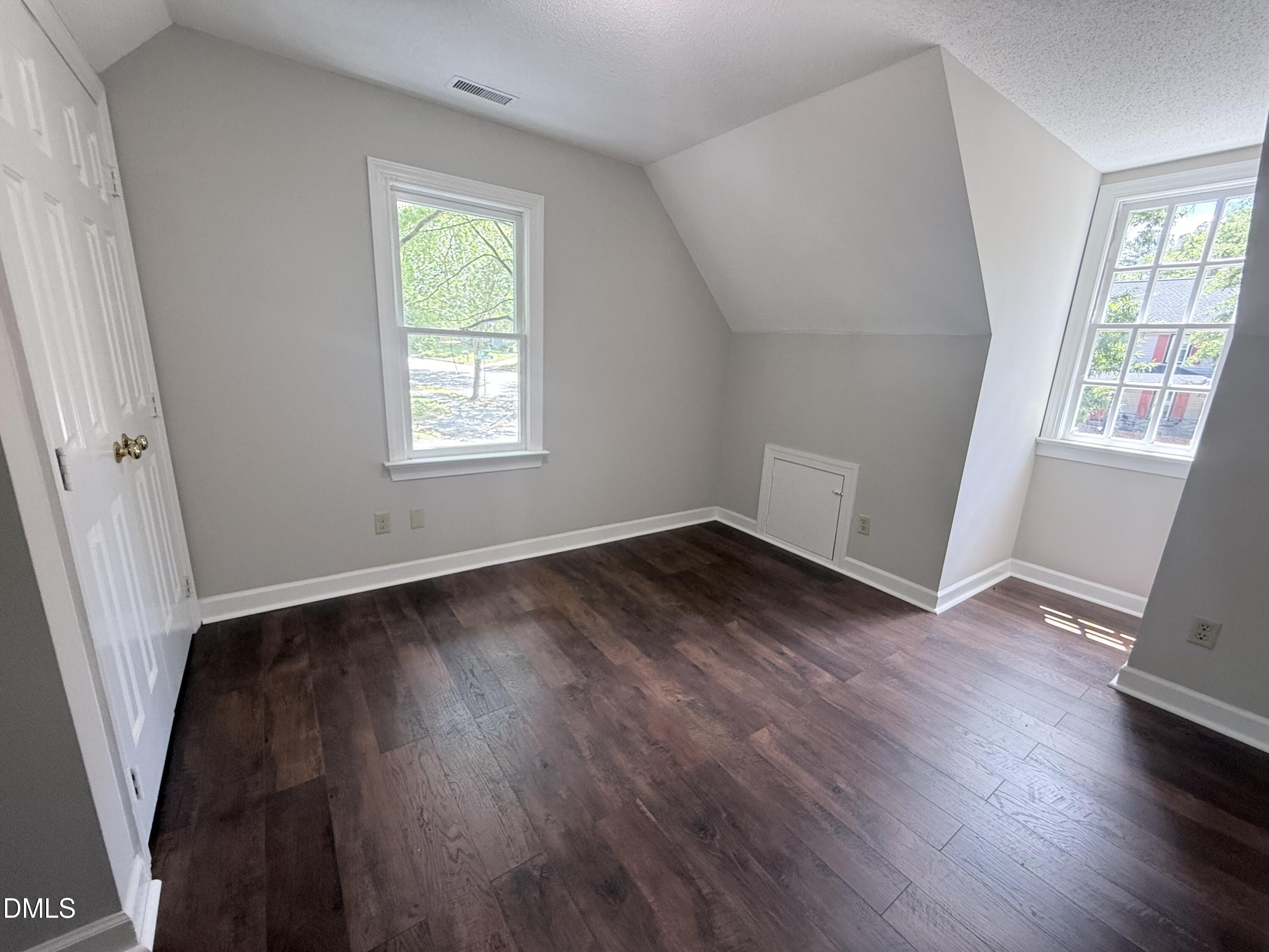 2900 Broadlands Drive Raleigh, NC 27604 - Photo 49 of 60 an empty room with wooden floor and windows