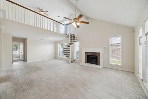 a view of a livingroom with a fireplace and window