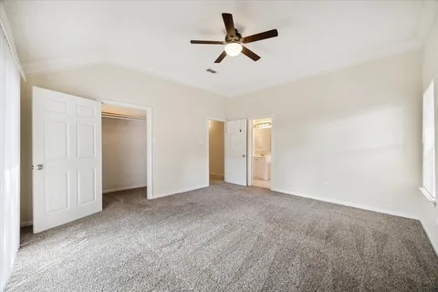 a view of a livingroom with a ceiling fan and window