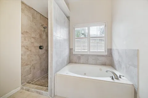 a bathroom with a bathtub and shower