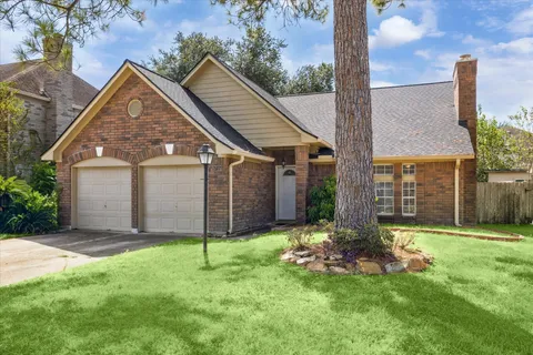 a view of a house with a yard and pathway