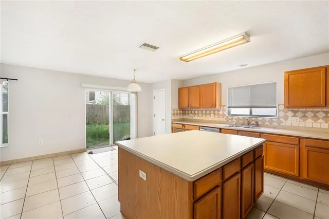 a kitchen with a sink a stove and cabinets