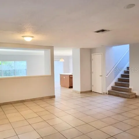 a view of a livingroom with wooden floor and stairs