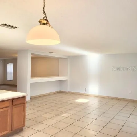 a large kitchen with granite countertop a stove a sink dishwasher and a refrigerator