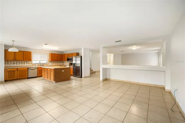 a large white kitchen with a stove a sink dishwasher and a refrigerator