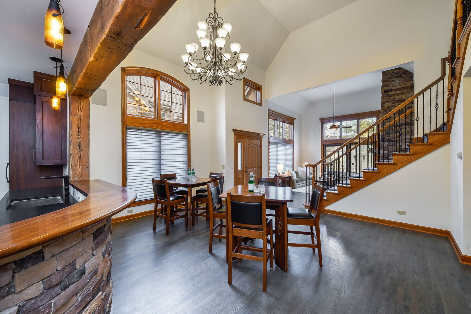 2009 Mackenzie Place, Unit 2009 Wheaton, IL 60187 - Photo 18 of 53 a dining room with wooden floor a chandelier a glass table and chairs