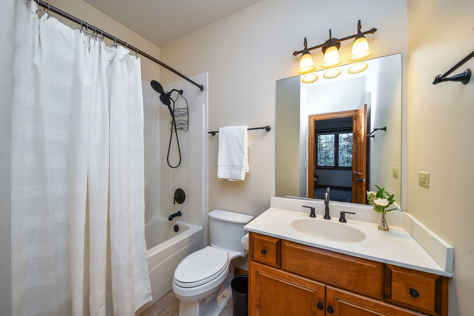 2009 Mackenzie Place, Unit 2009 Wheaton, IL 60187 - Photo 34 of 53 a bathroom with a sink vanity mirror and toilet