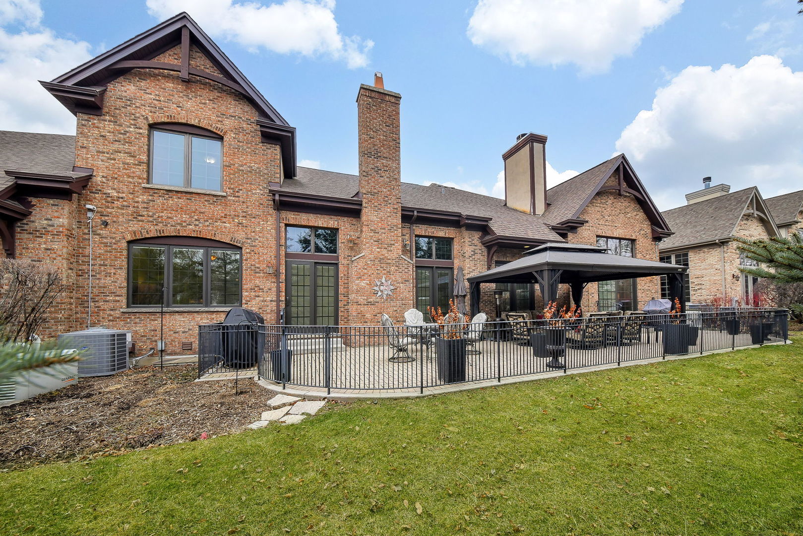 2009 Mackenzie Place, Unit 2009 Wheaton, IL 60187 - Photo 44 of 53 a front view of a house with patio and garden