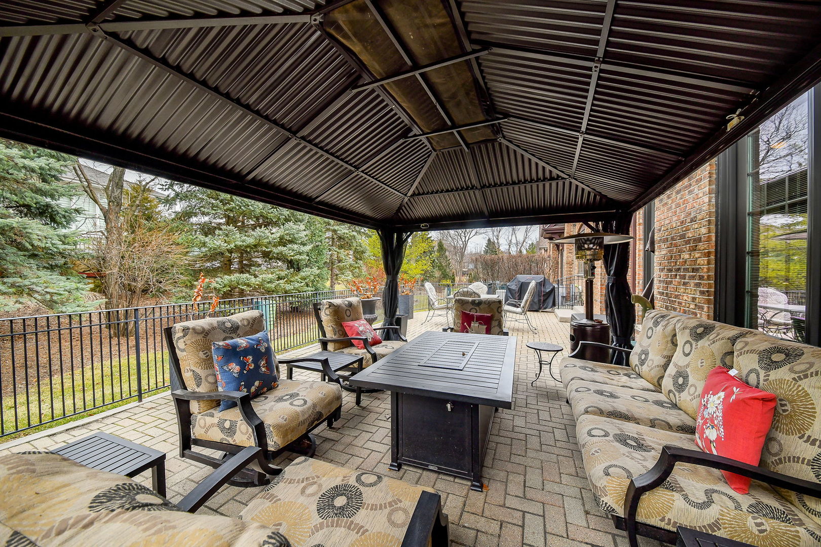 2009 Mackenzie Place, Unit 2009 Wheaton, IL 60187 - Photo 45 of 53 a view of a patio with table and chairs under an umbrella with a barbeque grill
