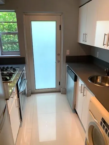 a kitchen with a refrigerator and a stove