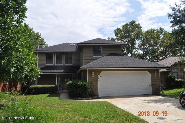 1711 Derringer Road Jacksonville, FL 32225 - Photo 1 of 25 a front view of a house with a garden and yard
