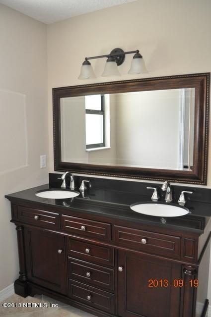 1711 Derringer Road Jacksonville, FL 32225 - Photo 18 of 25 a bathroom with a sink and a mirror