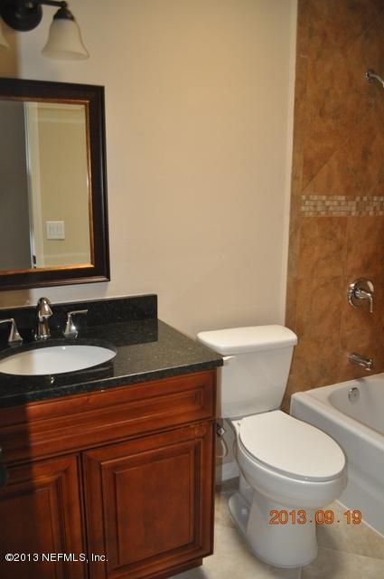 1711 Derringer Road Jacksonville, FL 32225 - Photo 23 of 25 a bathroom with a toilet a sink and mirror