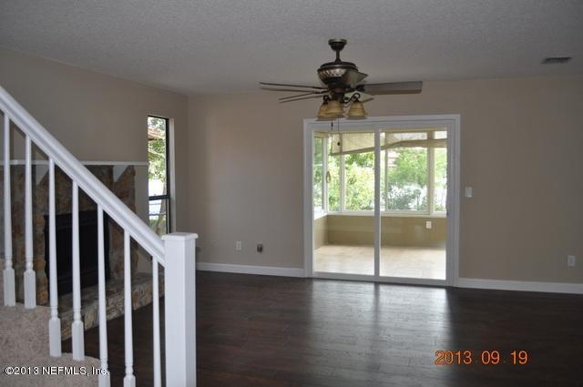 1711 Derringer Road Jacksonville, FL 32225 - Photo 3 of 25 a view of hallway with wooden floor and chandelier