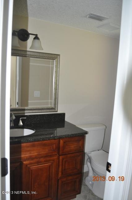 1711 Derringer Road Jacksonville, FL 32225 - Photo 4 of 25 a bathroom with a granite countertop sink and mirror