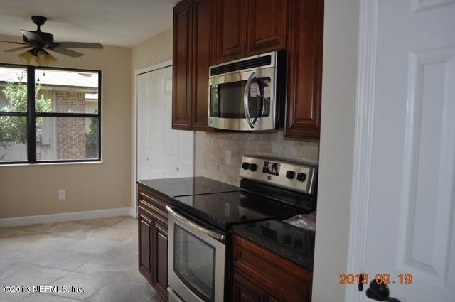 1711 Derringer Road Jacksonville, FL 32225 - Photo 8 of 25 a kitchen with a stove and a microwave