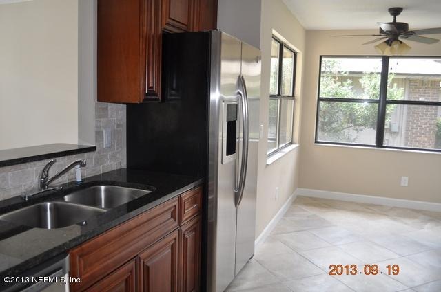 1711 Derringer Road Jacksonville, FL 32225 - Photo 9 of 25 a kitchen with a refrigerator and a sink