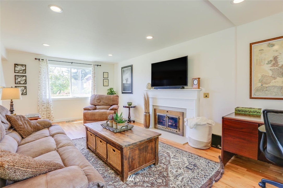 3522 Northeast 10th Place Renton, WA 98056 - Photo 12 of 34 a living room with furniture a flat screen tv and a fireplace