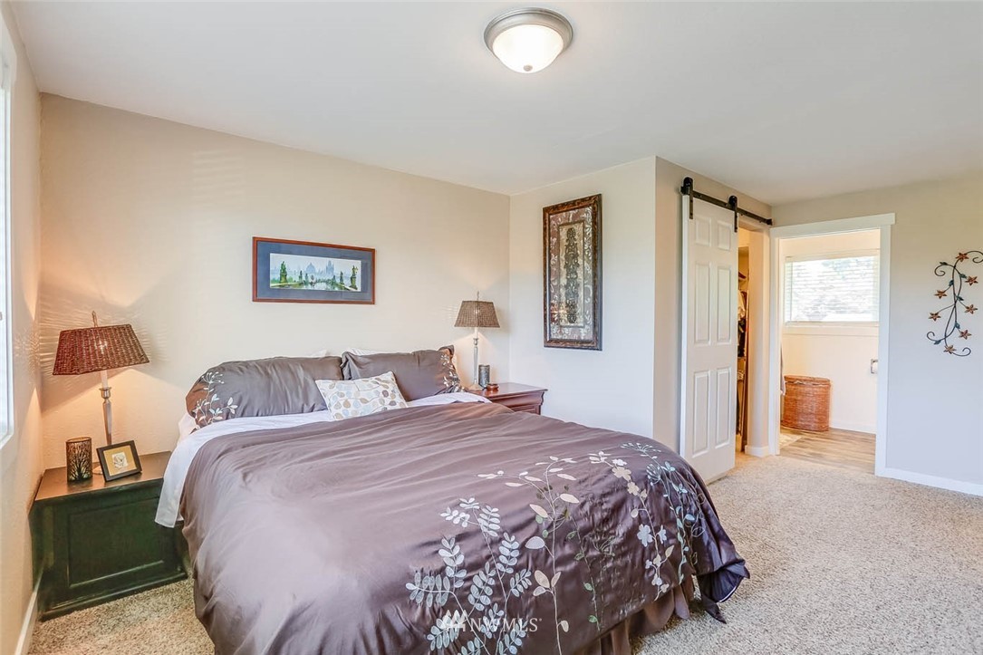 3522 Northeast 10th Place Renton, WA 98056 - Photo 15 of 34 a bedroom with a bed and a painting on the wall