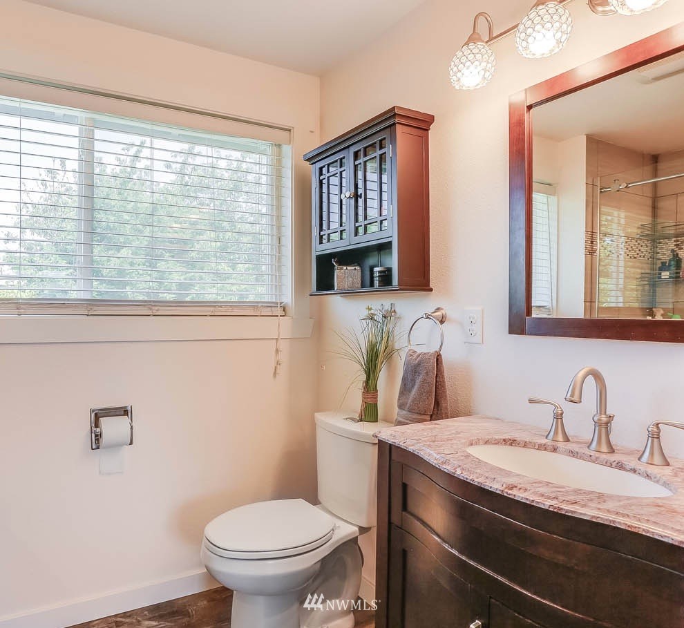 3522 Northeast 10th Place Renton, WA 98056 - Photo 18 of 34 a bathroom with a granite countertop sink toilet and mirror