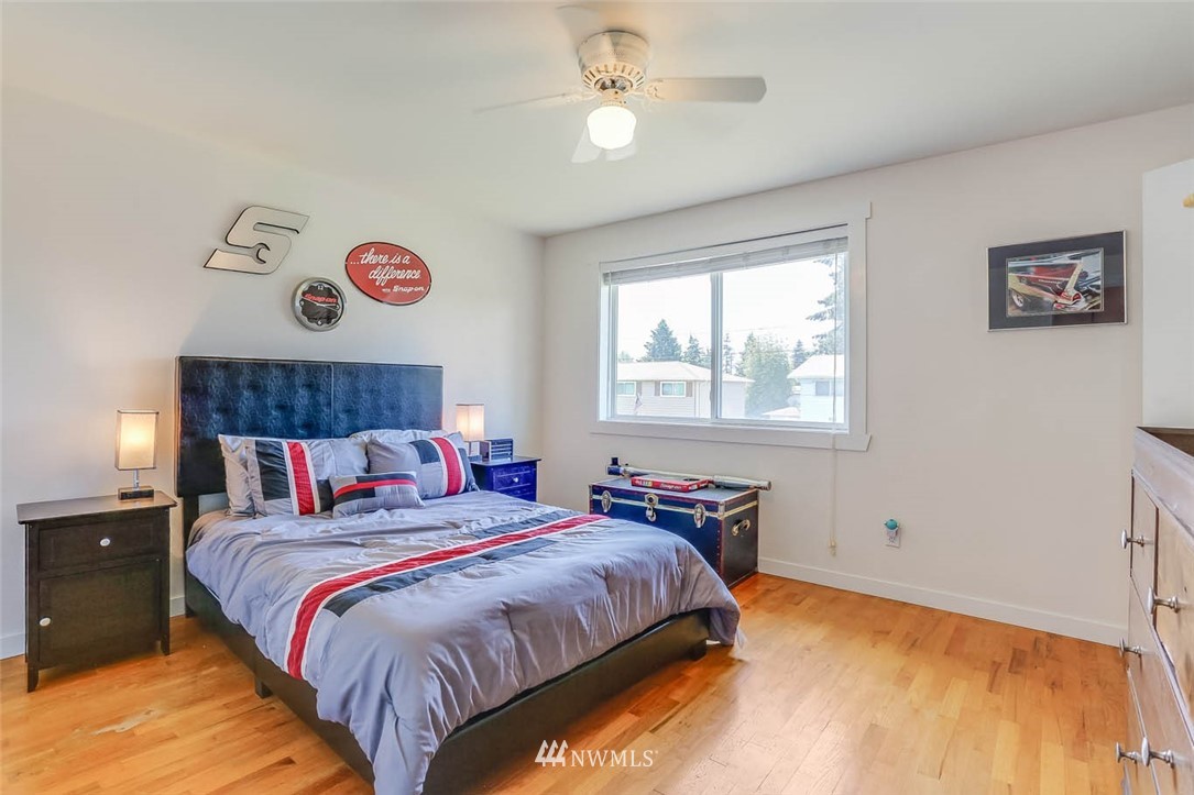 3522 Northeast 10th Place Renton, WA 98056 - Photo 20 of 34 a bedroom with a bed and a chandelier