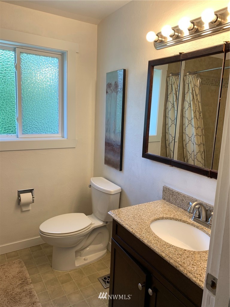 3522 Northeast 10th Place Renton, WA 98056 - Photo 24 of 34 a bathroom with a granite countertop toilet sink and mirror