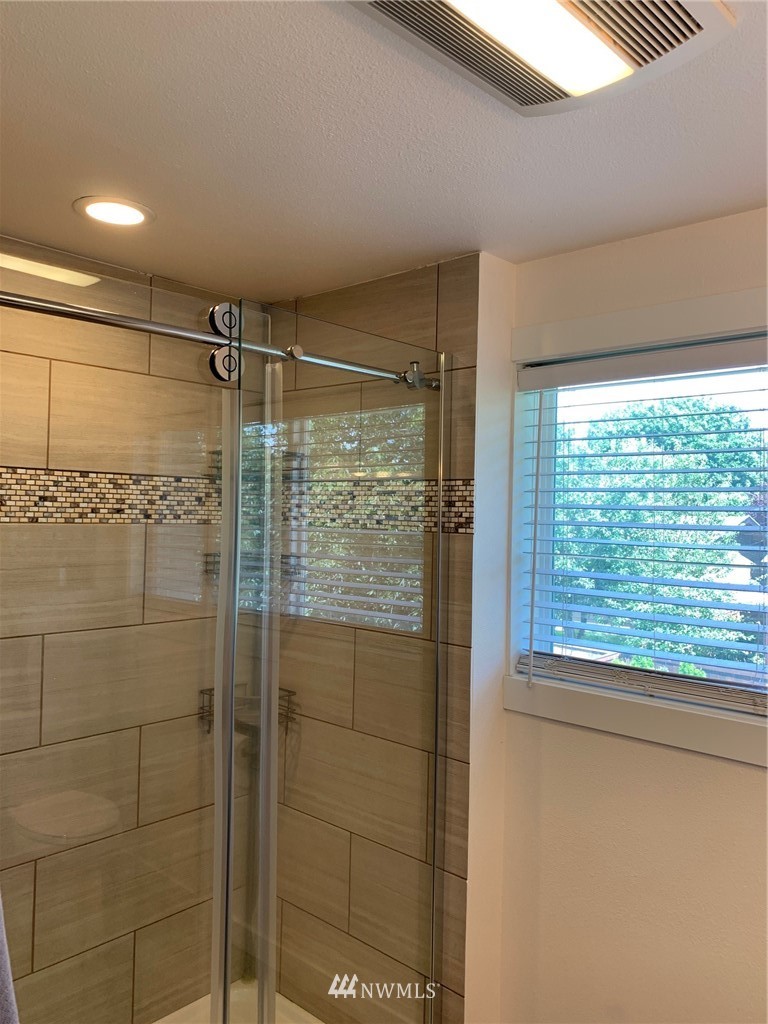 3522 Northeast 10th Place Renton, WA 98056 - Photo 26 of 34 a bathroom with a shower and a window