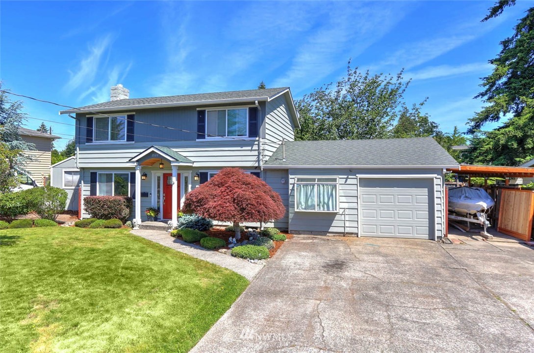 3522 Northeast 10th Place Renton, WA 98056 - Photo 34 of 34 a front view of a house with a yard and garage