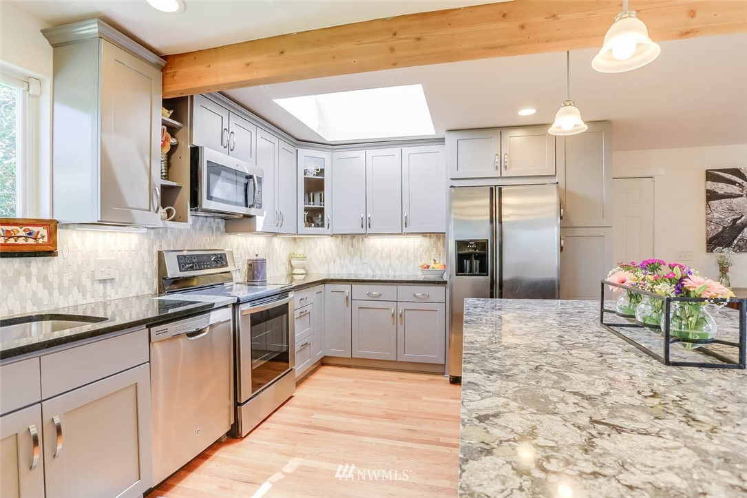 3522 Northeast 10th Place Renton, WA 98056 - Photo 6 of 34 a kitchen with stainless steel appliances kitchen island granite countertop a refrigerator and a sink