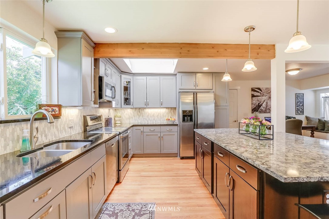3522 Northeast 10th Place Renton, WA 98056 - Photo 7 of 34 a kitchen with stainless steel appliances granite countertop sink stove and cabinets