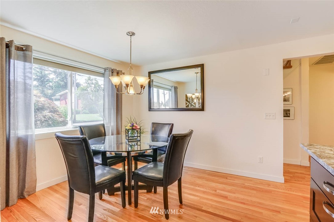 3522 Northeast 10th Place Renton, WA 98056 - Photo 10 of 34 a dining room with furniture a chandelier and wooden floor