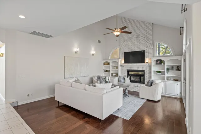 a large white kitchen with lots of counter space and stainless steel appliances