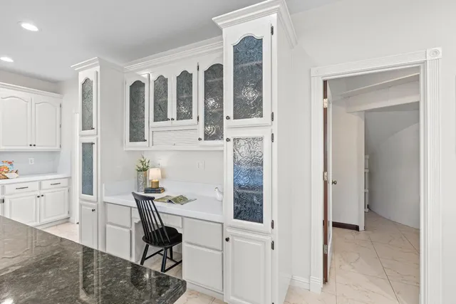 a kitchen with sink stove and cabinets
