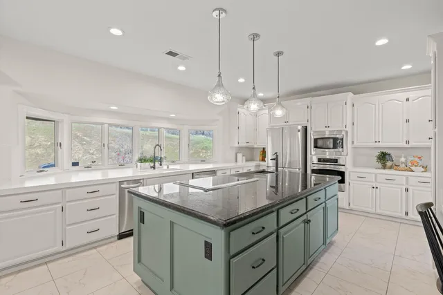a view of a dining room with furniture large windows and wooden floor
