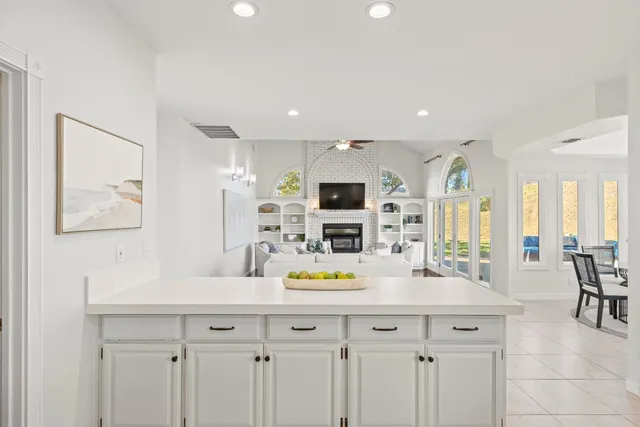 a spacious bedroom with a balcony furniture and a large window