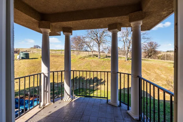 a view of a hallway with a chandelier fan and a dresser