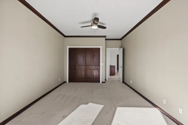 a front view of a house with a big yard and potted plants