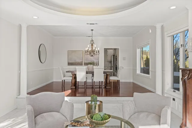 a living room with fireplace furniture and a chandelier