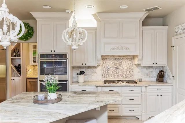 a large kitchen with granite countertop counter space a sink appliances and cabinets