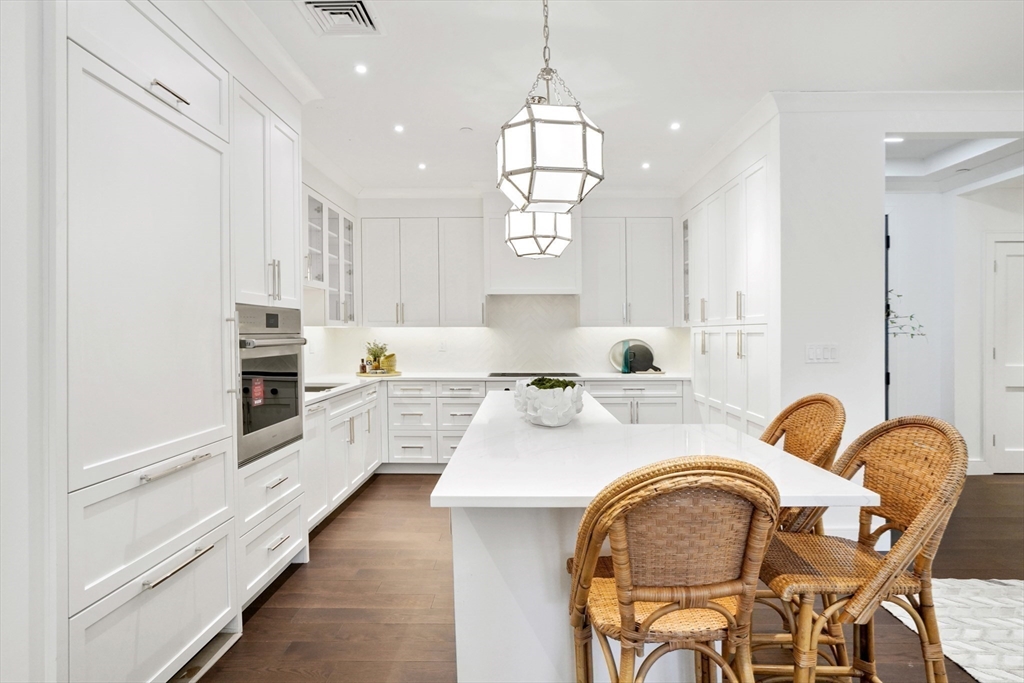 148 Weston Road, Unit 102 Wellesley, MA 02482 - Photo 15 of 32 a large kitchen with a table and chairs