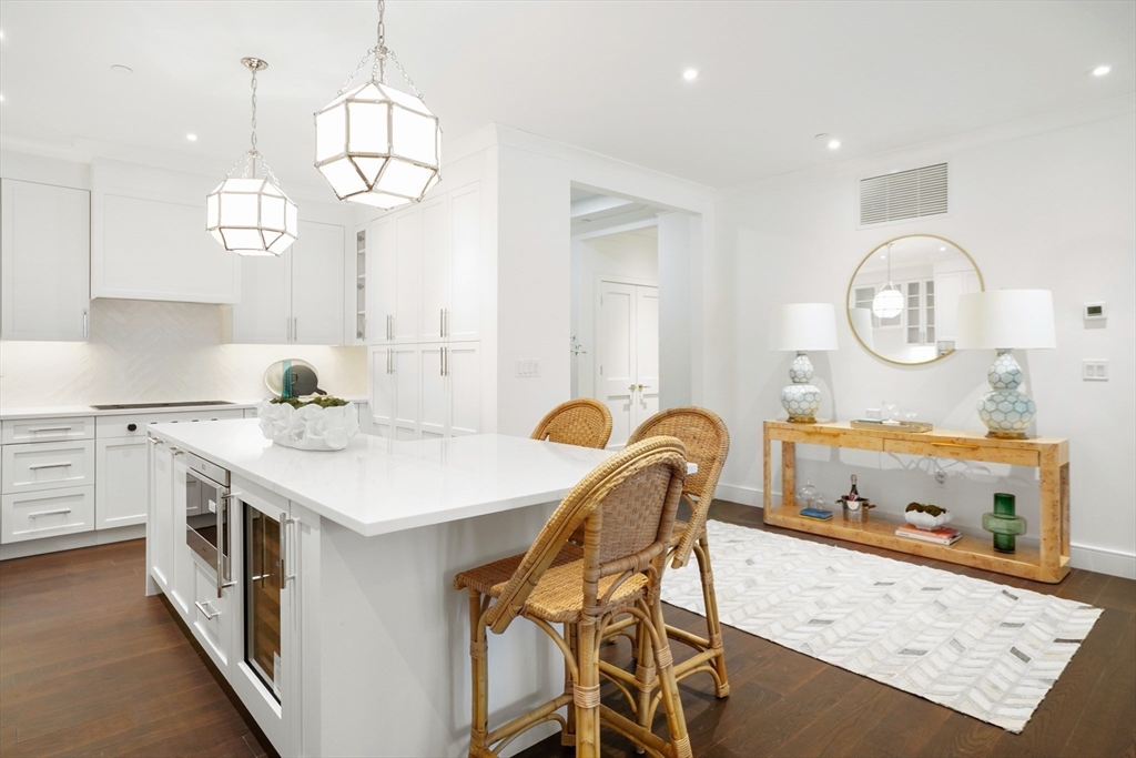 148 Weston Road, Unit 102 Wellesley, MA 02482 - Photo 17 of 32 a kitchen with a dining table and chairs