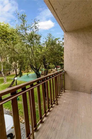 a view of a balcony with wooden floor