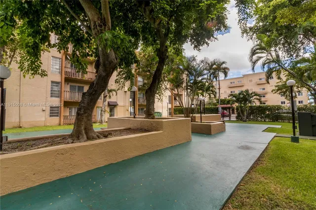 a view of swimming pool with lawn chairs and a big yard