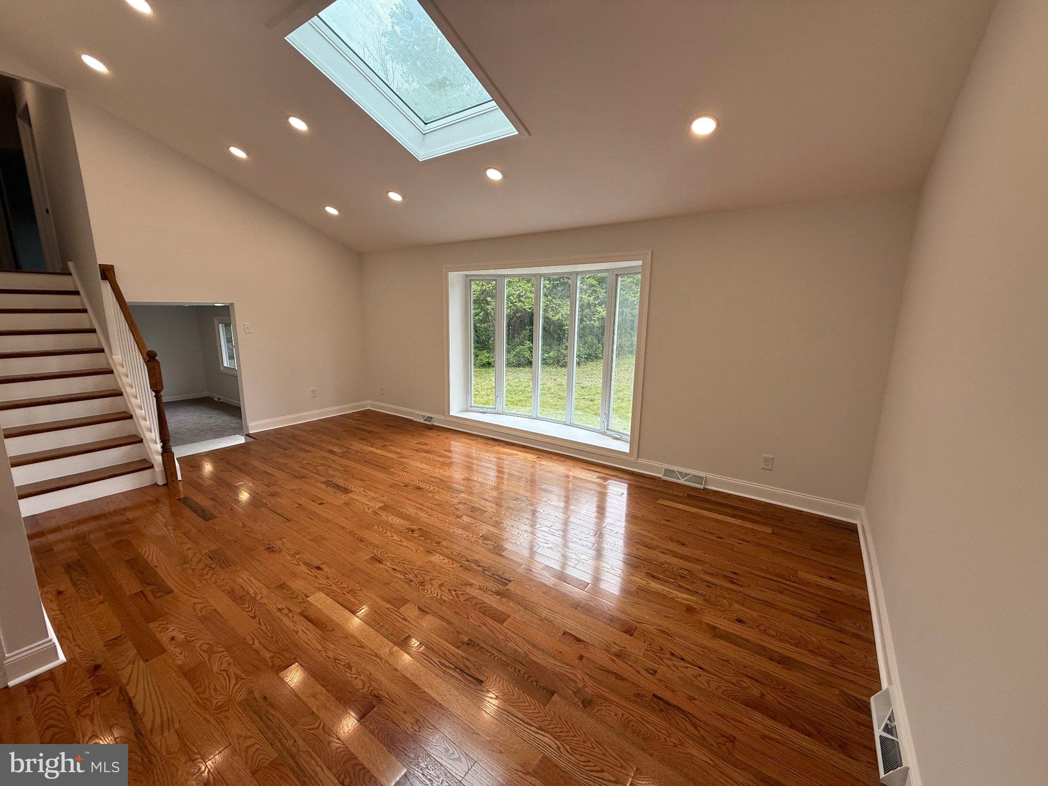 1104 Church Road Wyncote, PA 19095 - Photo 6 of 31 a view of an empty room with wooden floor and a window