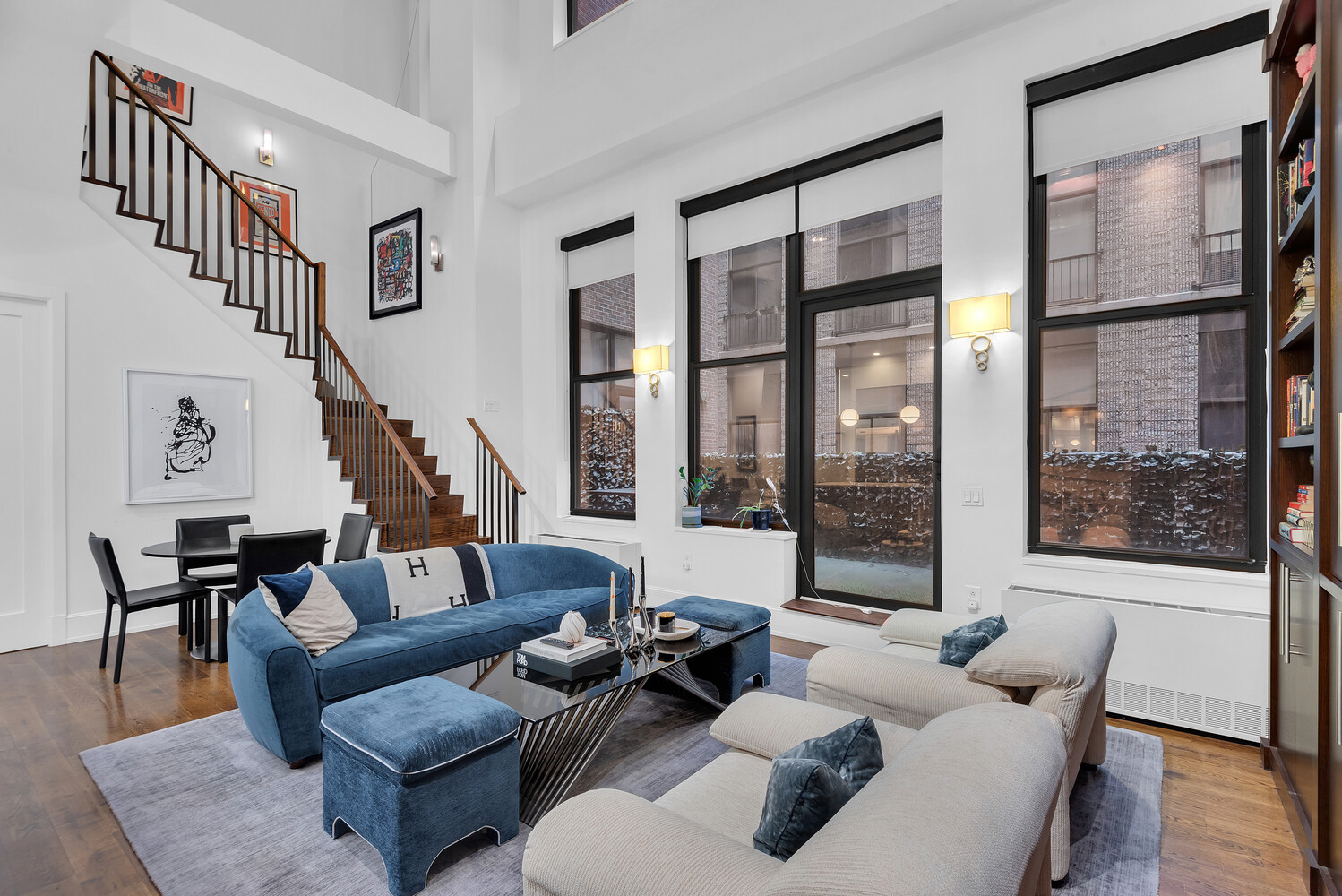 260 Park Avenue South, Unit 2E Manhattan, NY 10010 - Photo 2 of 20 a living room with furniture and floor to ceiling windows